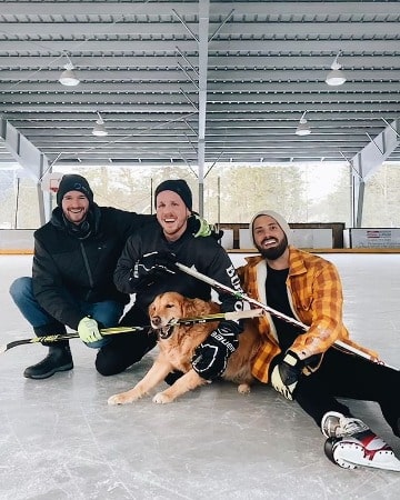 A smiling picture of Jean-Luc Bilodeau with his friends and pet dog